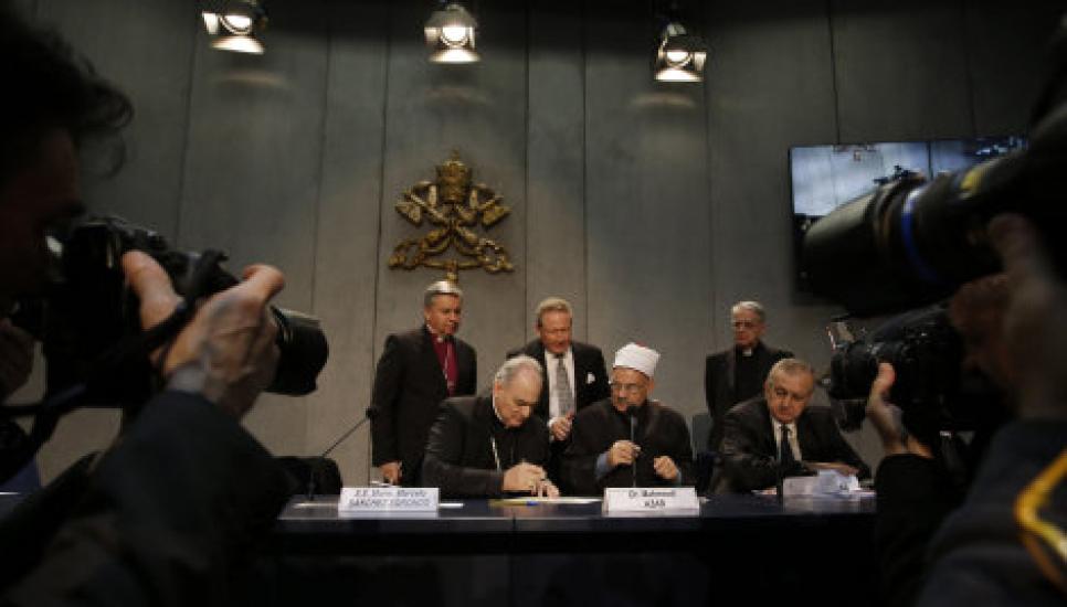 Andrew Forrest (centre back) watches over as religious leaders sign his agreement to slavery in their supply chains